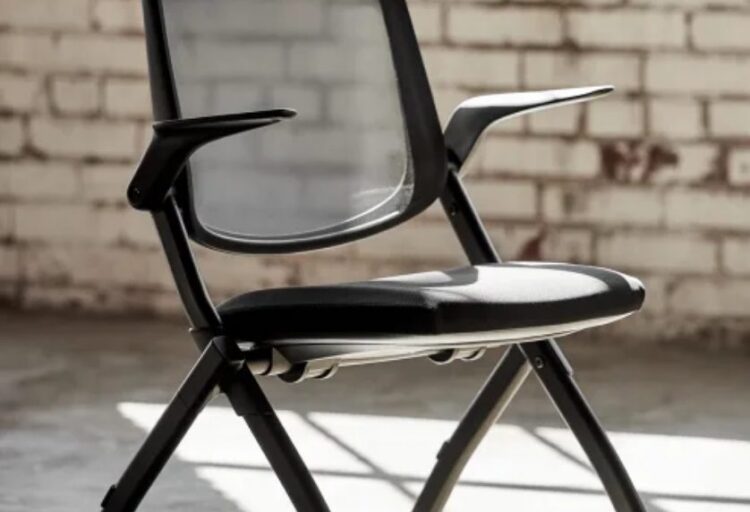 Chaddy chair in black in front of brick wall