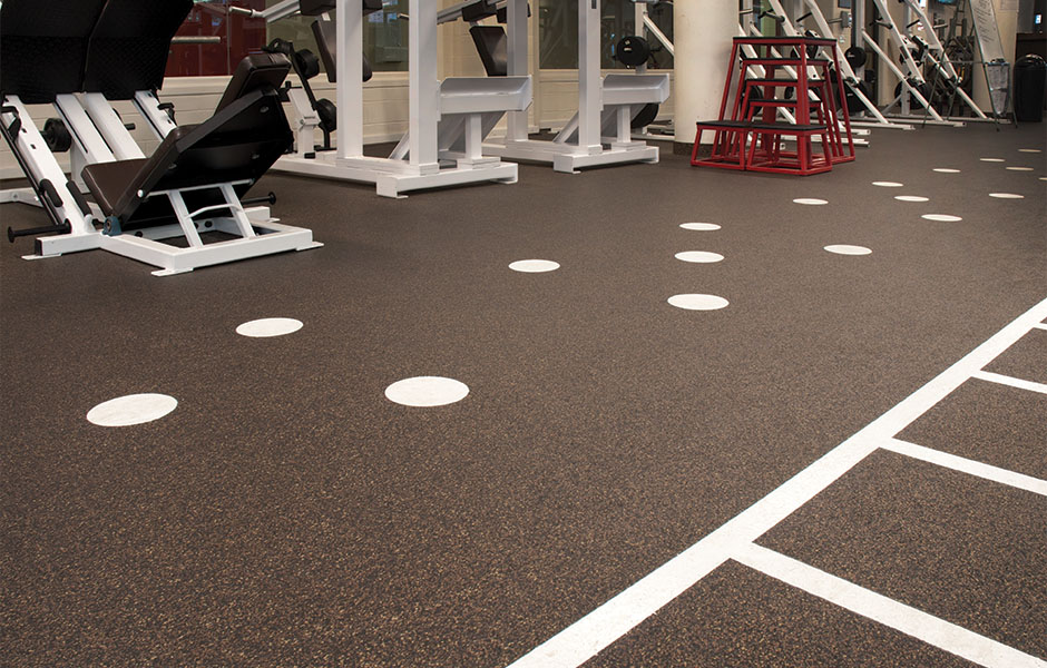 Play collection resilient floor brown speckled rubber with large white dots in gym with machines