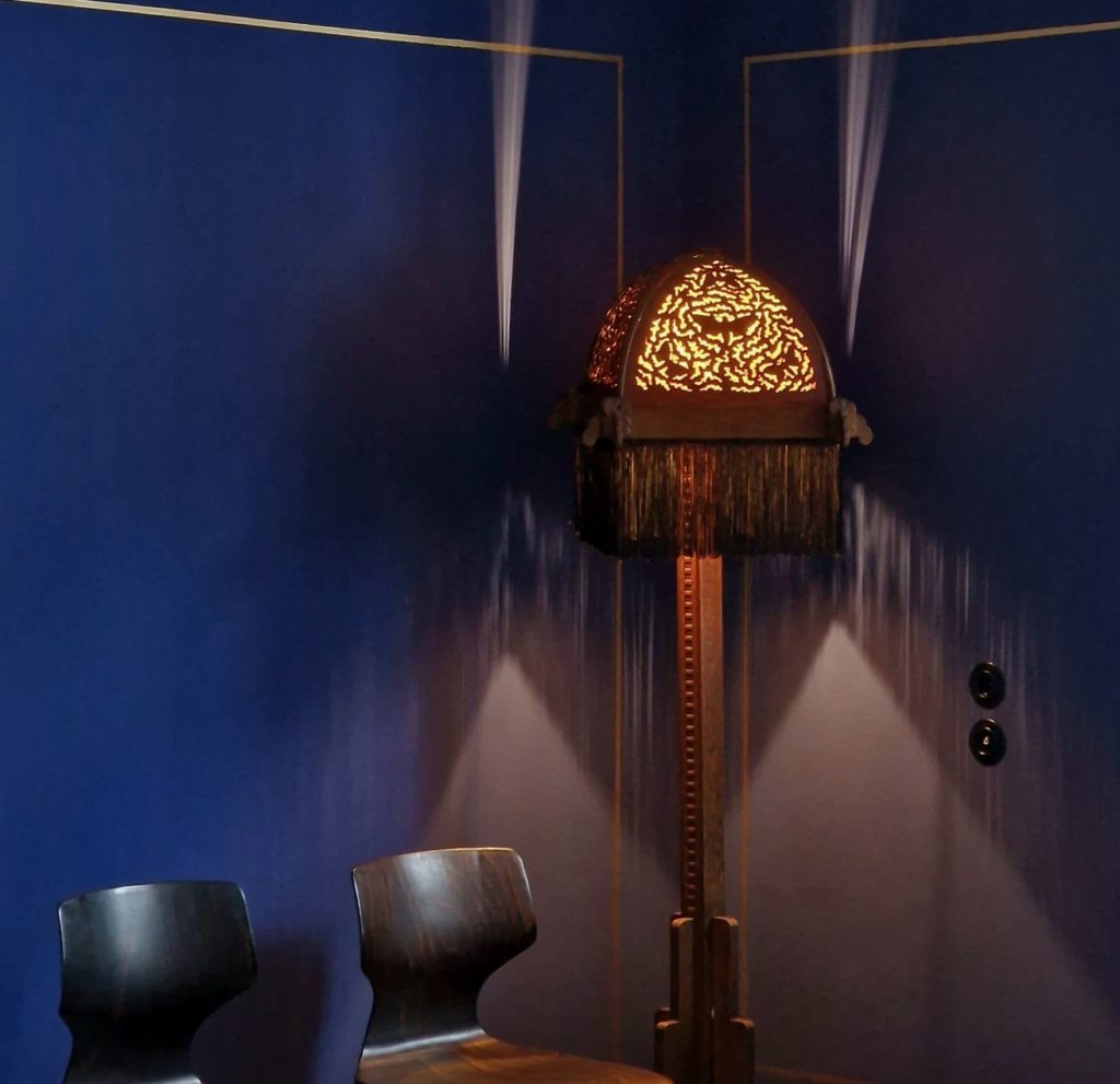 Apartment interior with Art Deco lamp with tassels and design carved into the shade