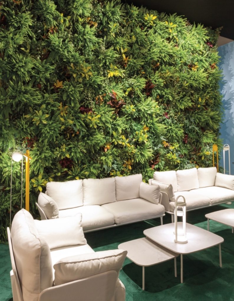 Giravolta three lamps on patio with wall of greenery