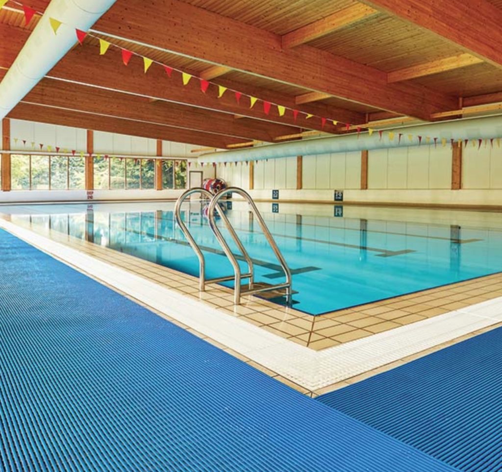 Swimming pool surrounded by Play collection non-slip matting