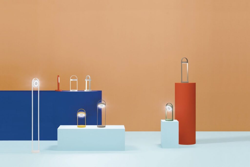 Several lamps with rotating diffuses atop pedestals of different heights and colors
