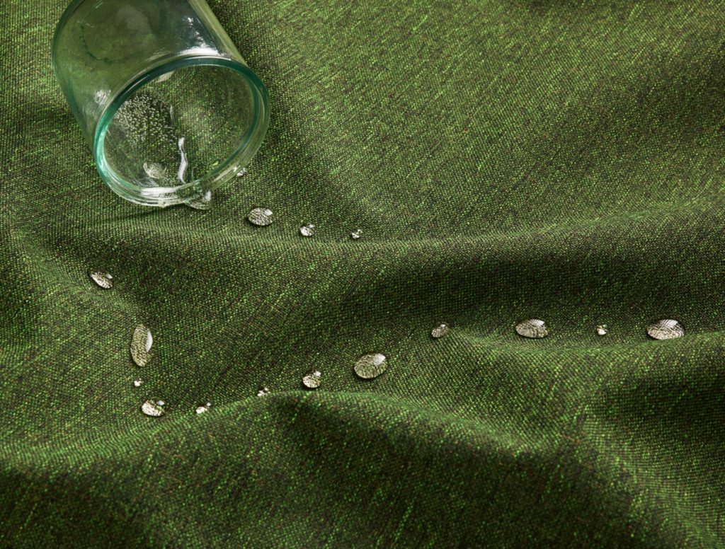 Supreen green textiles with water spilled and beading up