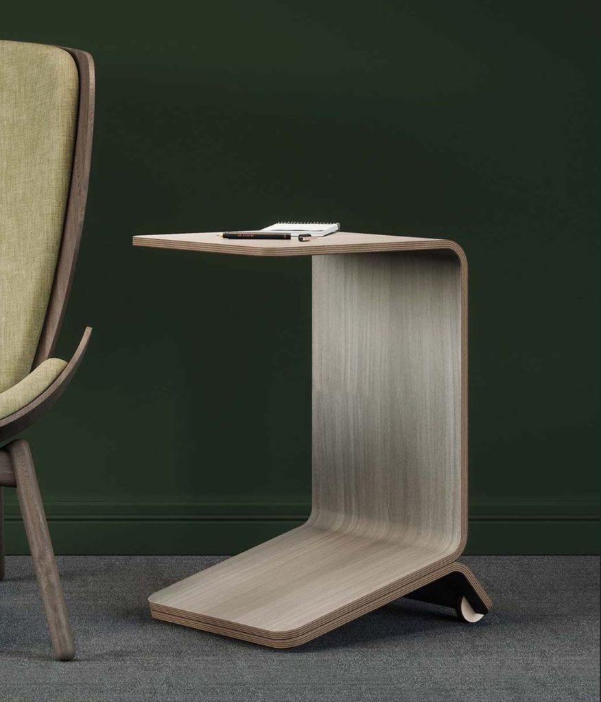 Willow table in gray next to partial view of green upholstered chair