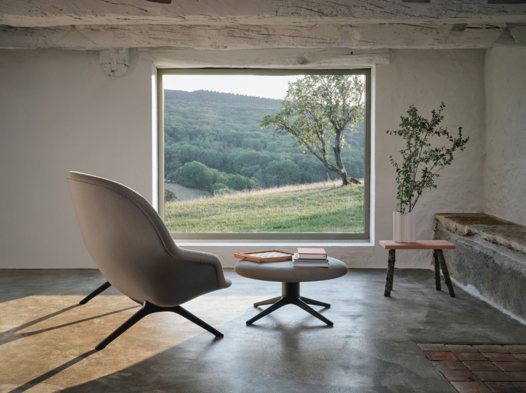 Abalon sofa and ottoman in spare room with picturesque view of forested hillside