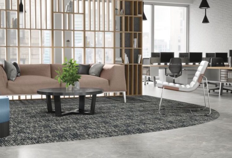 Even Plane in gray next to modular carpet in open office