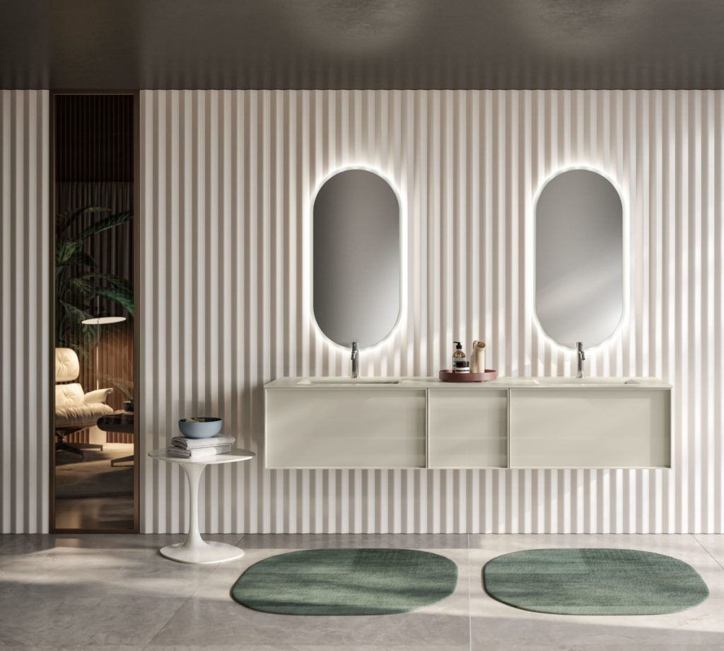 Class vanity in glass with oval shaped, back-lit mirrors above