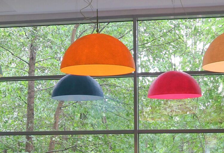 Mezza Luna pendant in multiple colors hanging in front of window