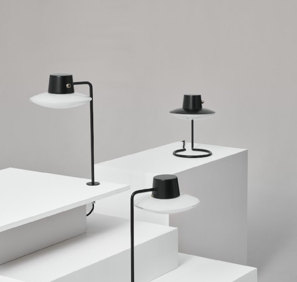 Three lamps on white shelves