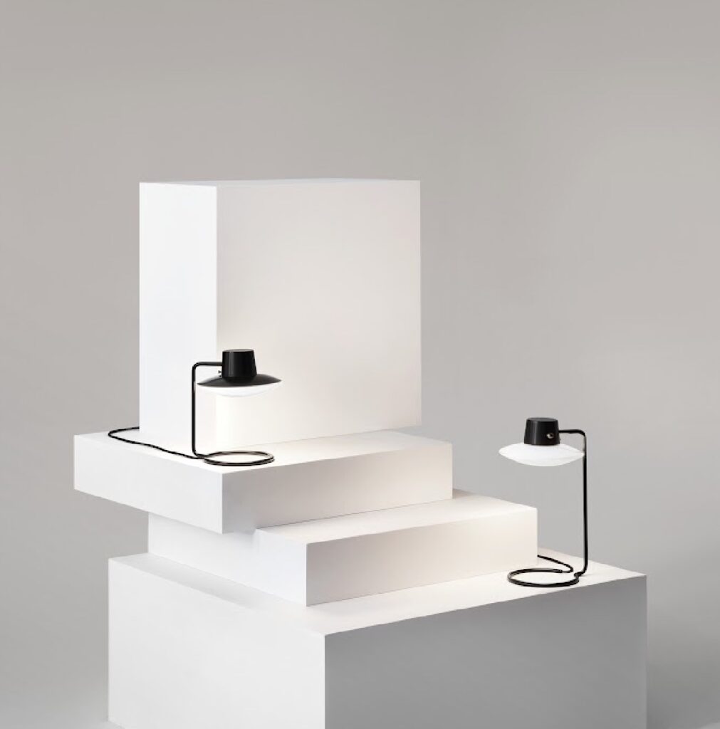 two lamps on white pedestal one with metal top shade and one without