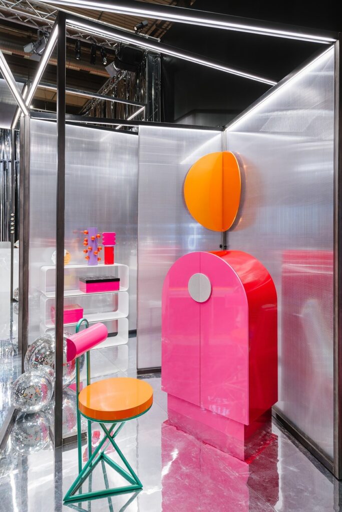 Cyber chair in arty display with other colorful and shiny objecrts