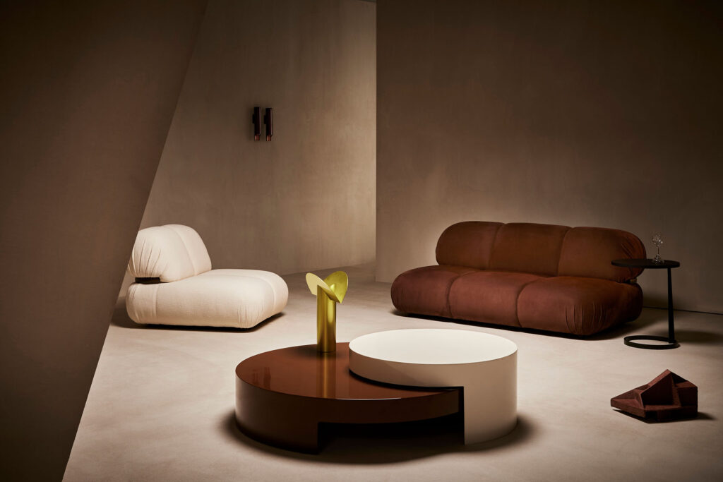 Bold sofa in rust and Bold armchair in white in room with matching rust/white modern table