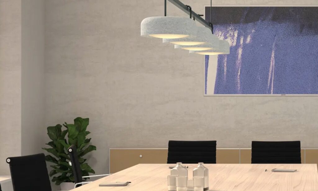 Felt shade fixtures above conference table in work setting