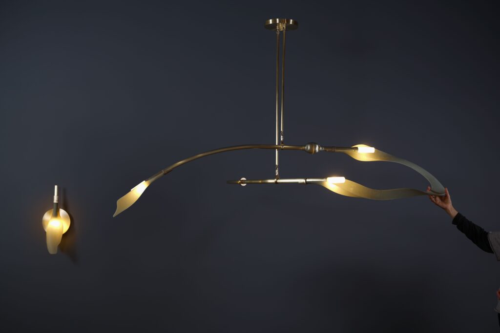 Sconce and pendant with hand visible