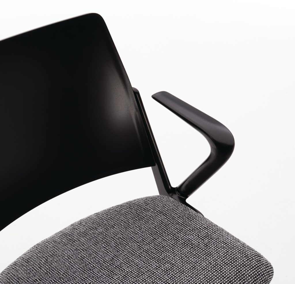 Detail of chair with upholstered seat in gray/black check fabric and black seat back