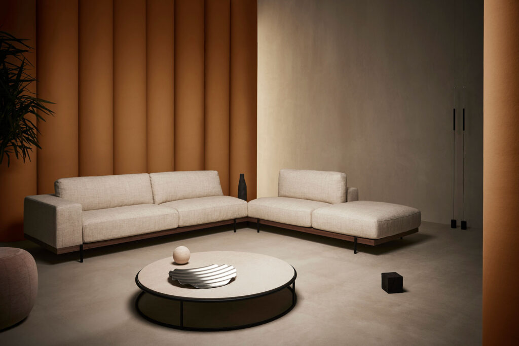 Sailor sofa: modular/sectional sofa in white with circular table on concrete floor