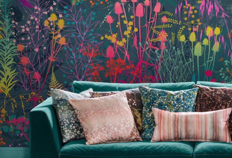 Serendipity Rainbow design of vibrant colored wildflowers on a dark green/blue background with green sofa in front.