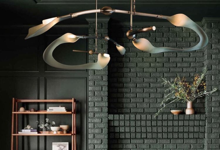 Pisces Swell chandelier in nice room with dark brick wall