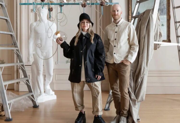 The creators at the photo shoot with blownglass chandelier in background
