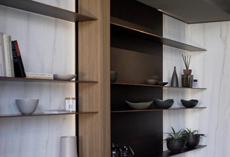 Vena Oro on wall in living area with shelves and center storage case