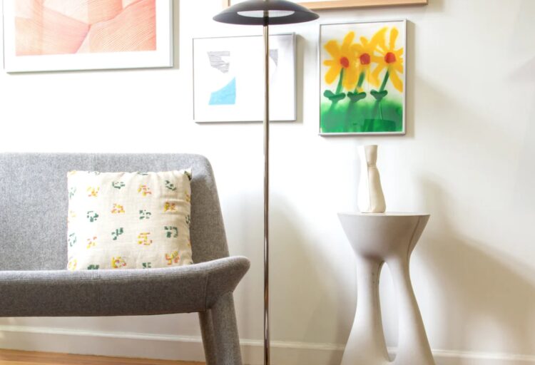 Signal table lamp in pleasant room with art and partial view of sofa