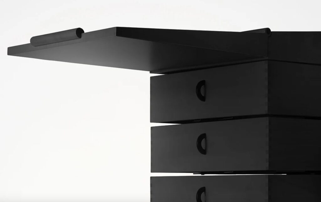 Black chest of drawers with flip-top writing top