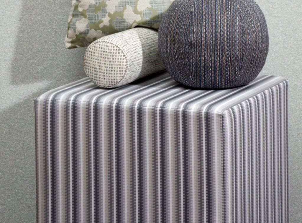 Stripe textile on an ottoman with stripes in different shades of gray