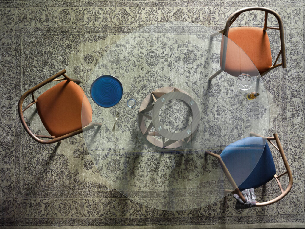 View from above at circular glass table with colorful chairs