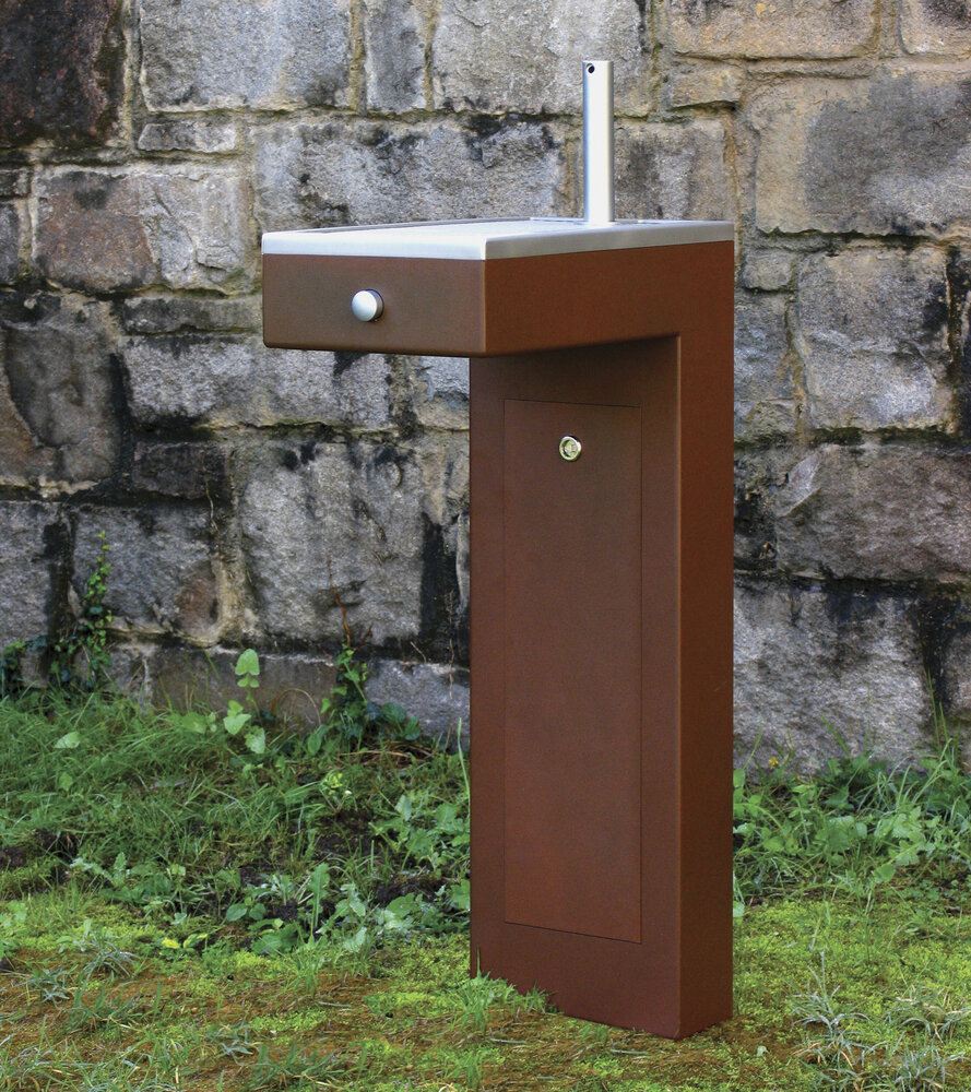 Caudal water fountain with old stone wall