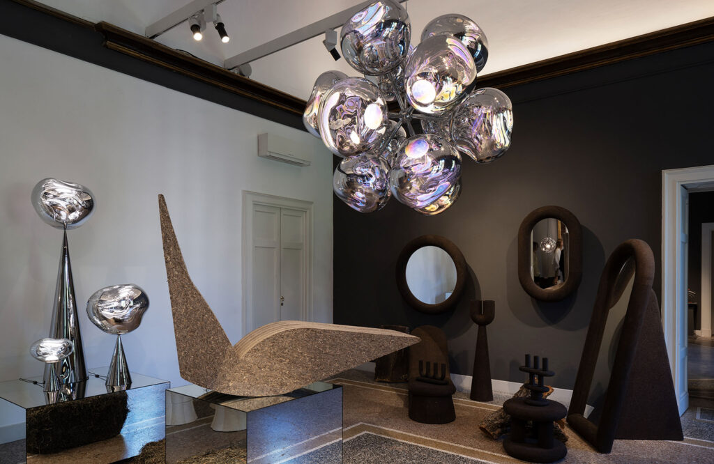 Bird chair made of sustainable eelgrass beneath Tom Dixon Melt chandelier