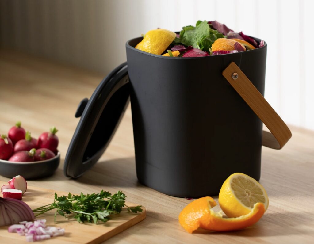 Bamboozle in black with fruit scraps and kitchen cutting board