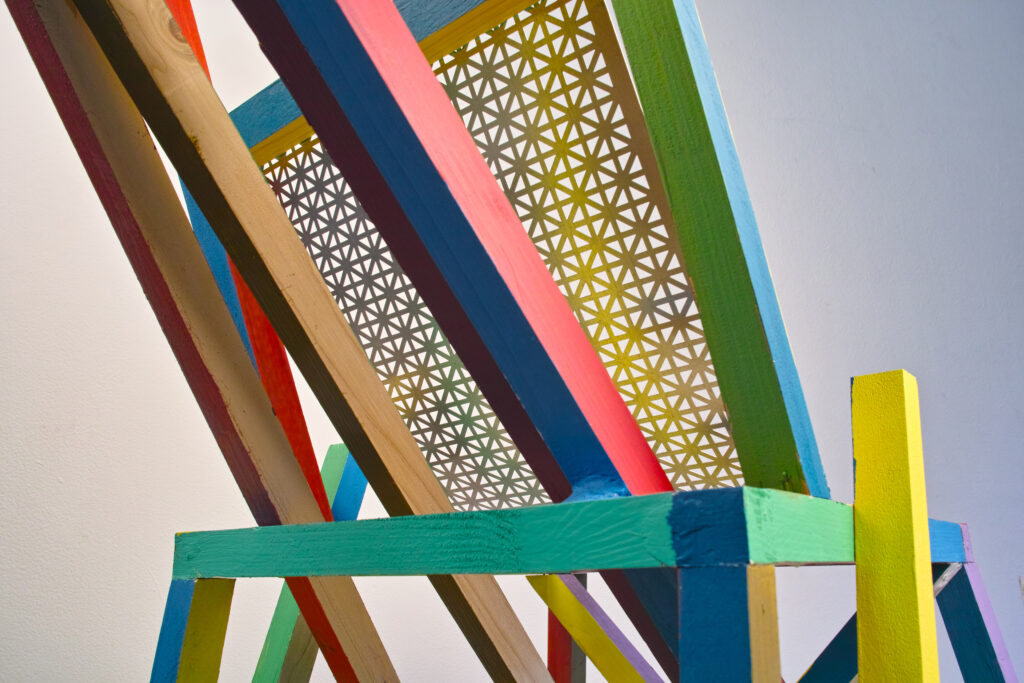 Detailed view from back showing back webbing and painted lengths of wood