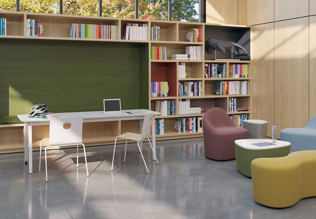Two chairs, tables, and ottoman in classroom