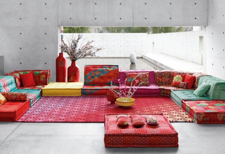 Mah Jong sofa Hiru-Kenzo many colors in reddish palette in spare room with concrete floor
