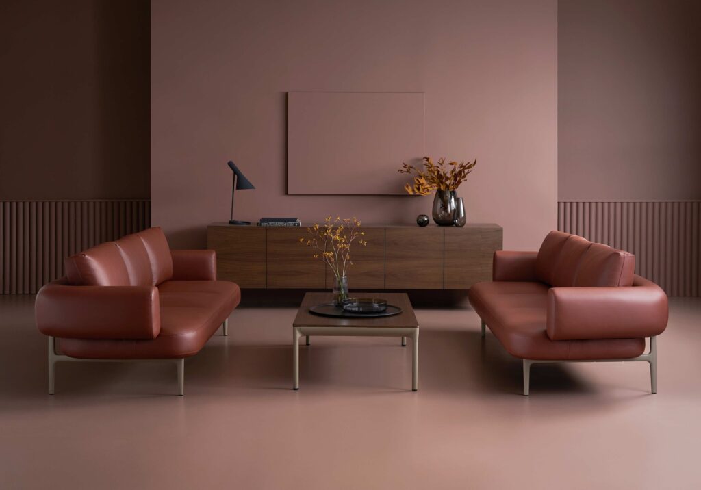 Casen two sofas in brown/rust color facing each other in nice sitting room