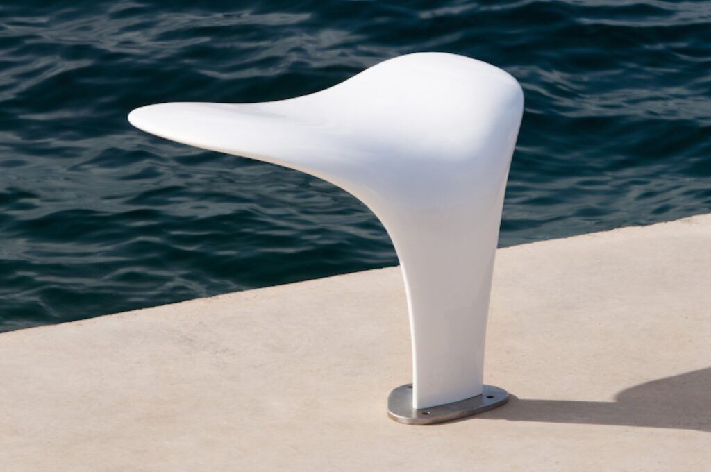 White outdoor tail bench near the ocean