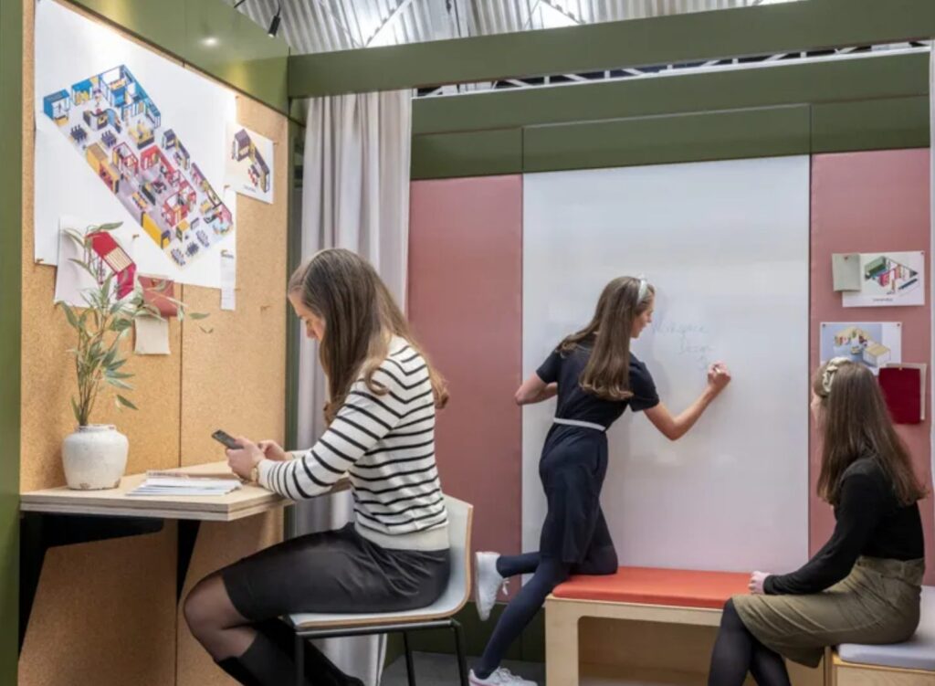 Verandas interior view with women working and whiteboard wall