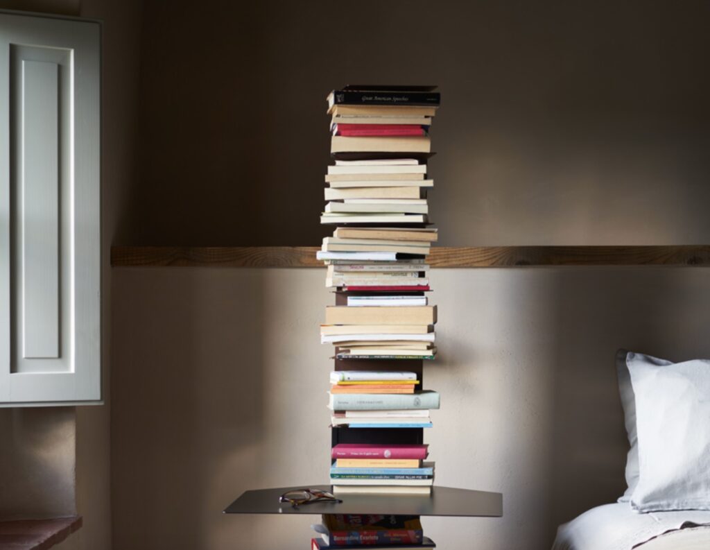 Ptolomeo full of books next to bed