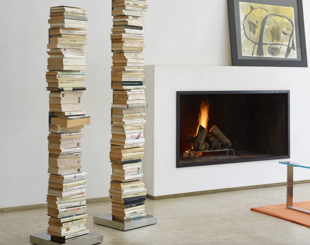 two bookcases side by side next to the fire
