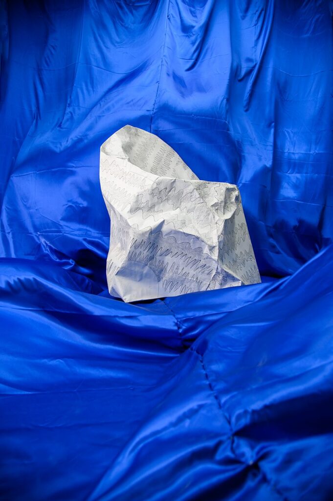 Paper collection chair, blue background