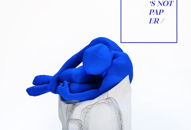 Paper Collection chair with man dressed in blue skin suit