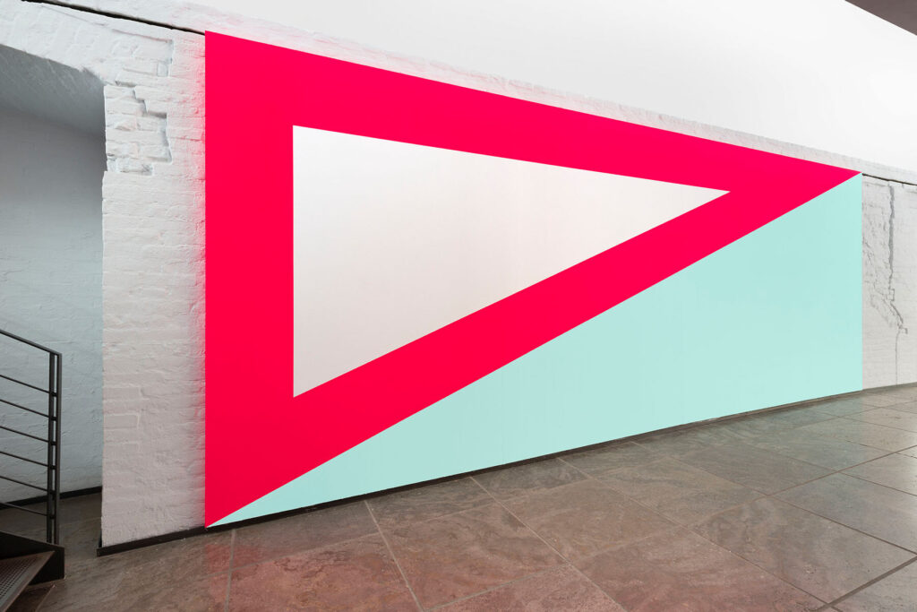 wall painted in light blue and red/white in the form of long triangles