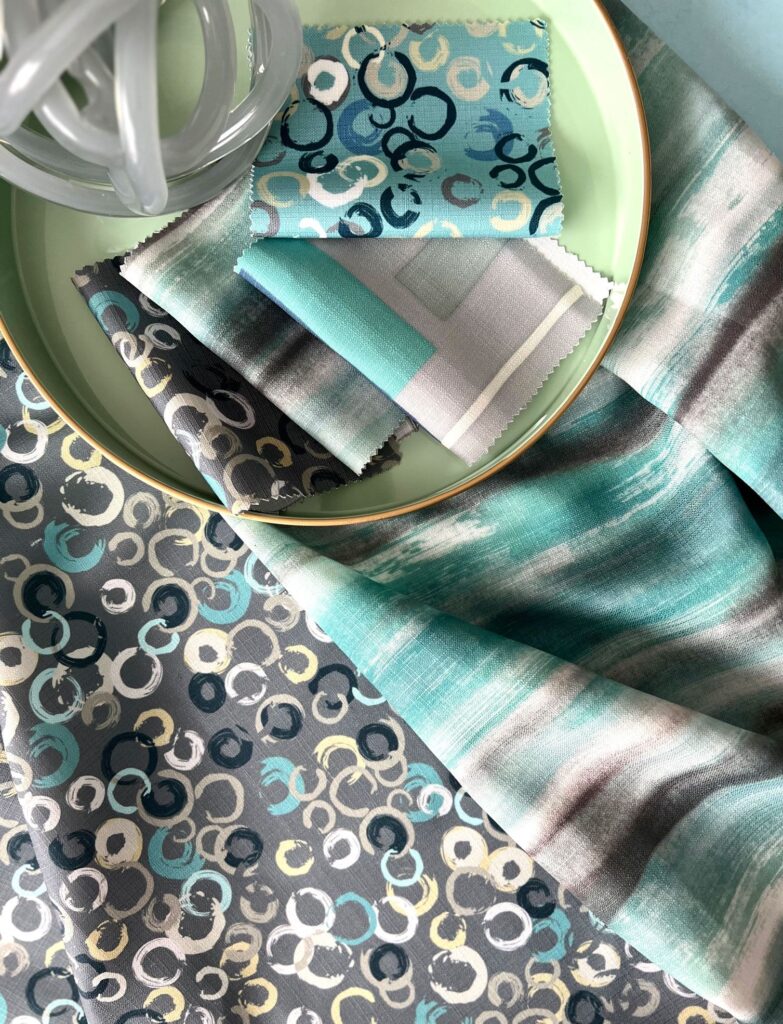 fabrics in blues and green with circle patterns and cloud-like forms