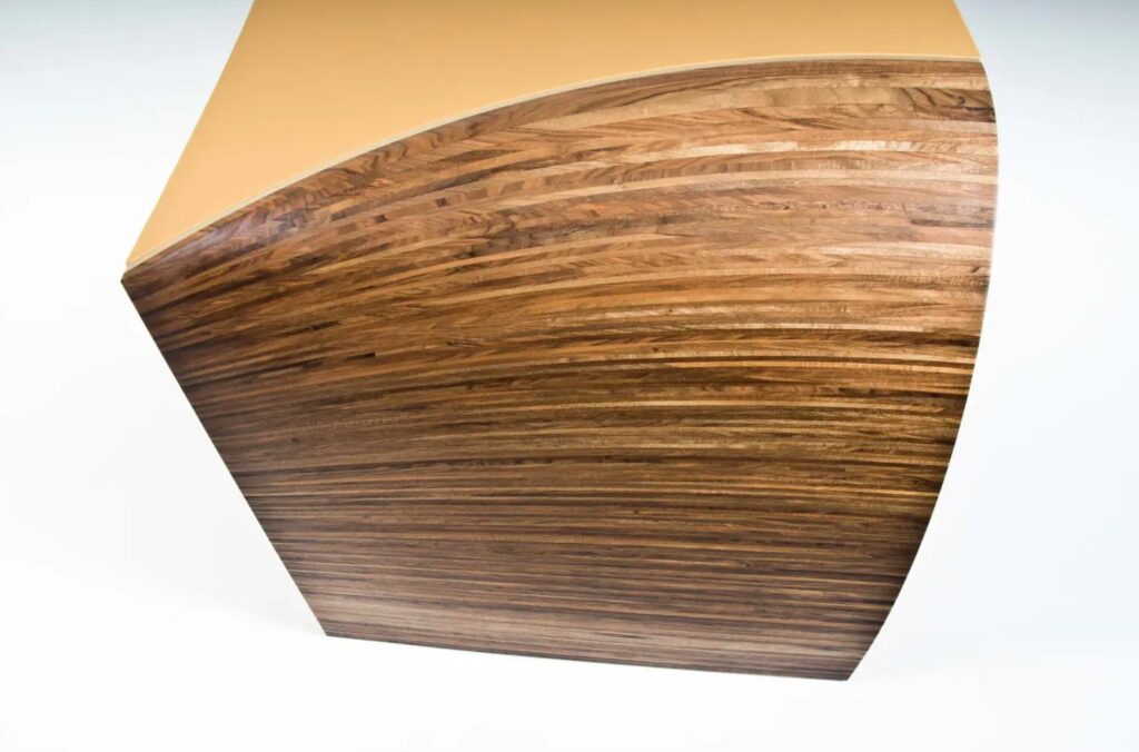 Side view of Radium desk showing curved leg