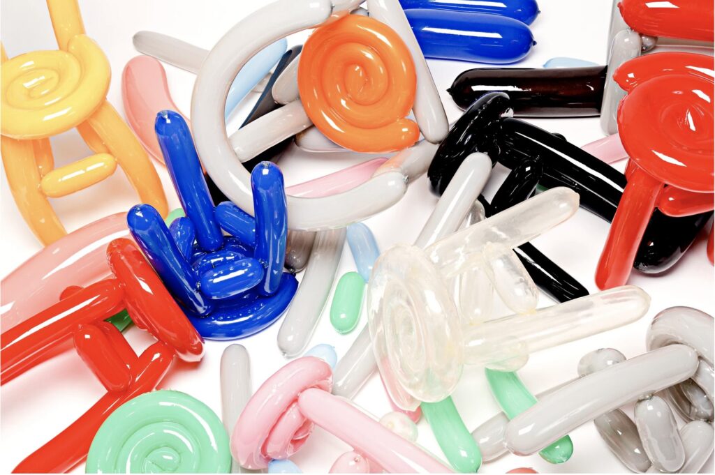Assortment of balloon stools on the ground in many colors