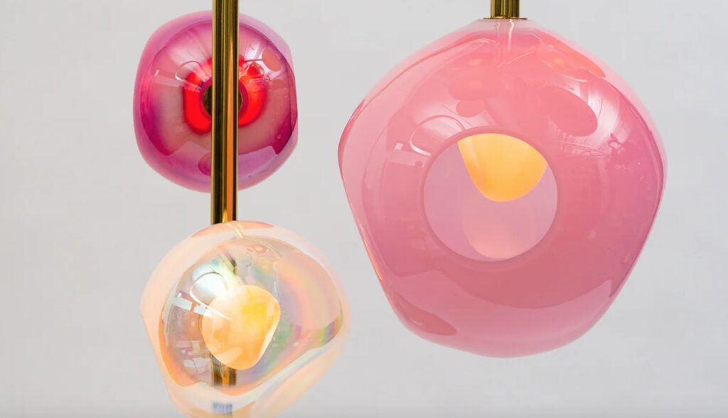 Chandelier detail with clear, reddish, and pink bulbs