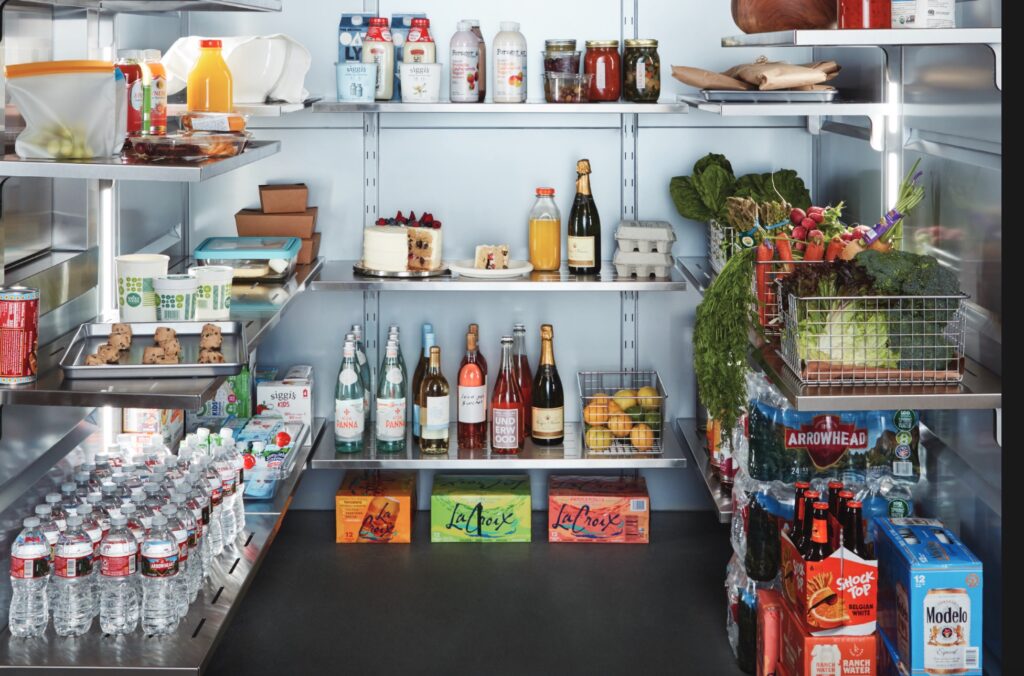 walk-in refrigerator with variety of drinks, eggs, veggies