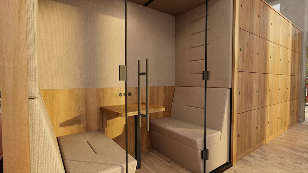 Portals Huddle view from outside with slightly tinted glass doors, nice wooden desk, and tan upholstery