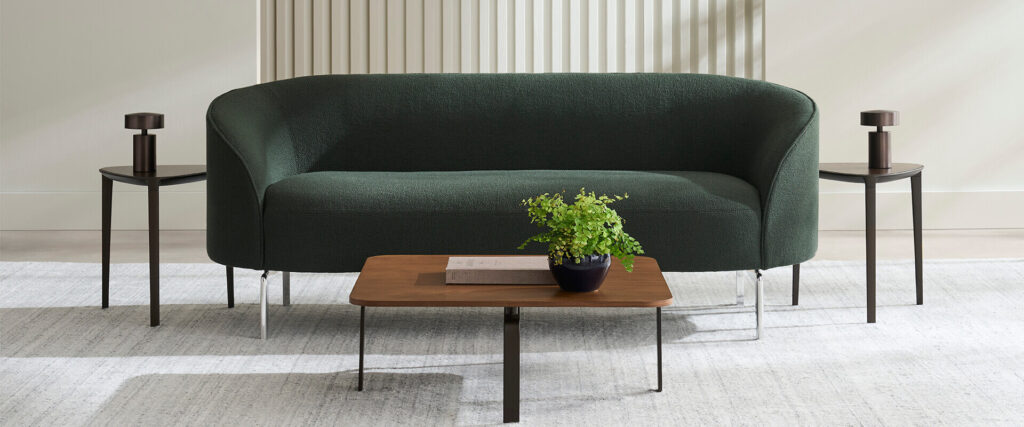 Arcular green three-seater in bright room
