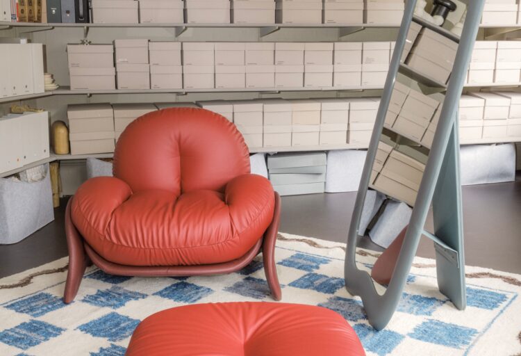 In red with ottoman, rug, and mirror
